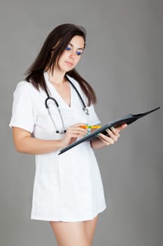 medical doctor woman with stethoscope. A female doctor with a folder