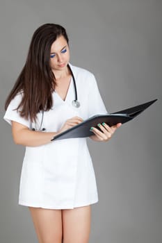 medical doctor woman with stethoscope. A female doctor with a folder