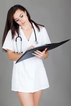 medical doctor woman with stethoscope. A female doctor with a folder