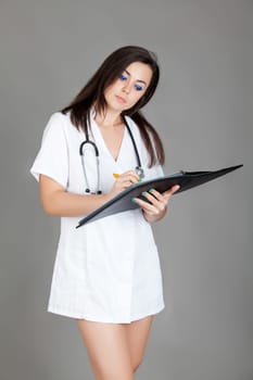 medical doctor woman with stethoscope. A female doctor with a folder