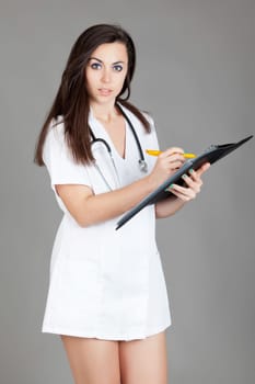 medical doctor woman with stethoscope. A female doctor with a folder