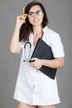 medical doctor woman with stethoscope. A female doctor with a folder