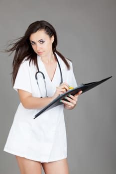 medical doctor woman with stethoscope. A female doctor with a folder