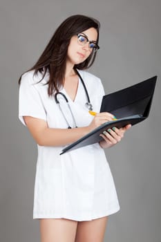 medical doctor woman with stethoscope. A female doctor with a folder