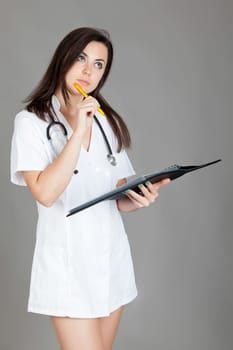 medical doctor woman with stethoscope. A female doctor with a folder