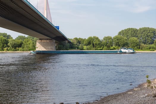 A ship passes under a bridge over the Rhine
