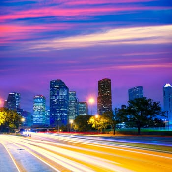 Houston Texas modern skyline at sunset twilight with traffic headlights lights trace