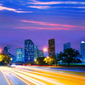 Houston Texas modern skyline at sunset twilight with traffic headlights lights trace