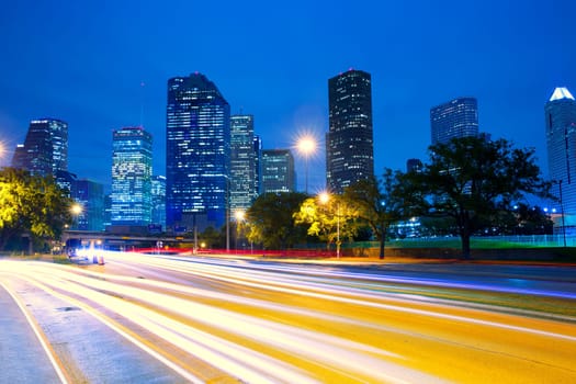 Houston Texas modern skyline at sunset twilight with traffic headlights lights trace