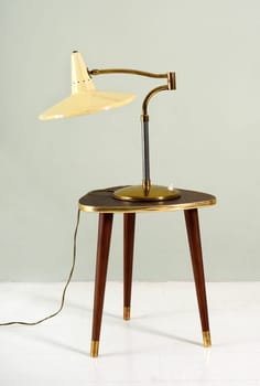 Vintage iron lamp over a wood and bass stool
