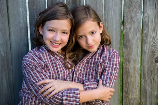 twin girls fancy dressed up pretending be siamese with his father shirt