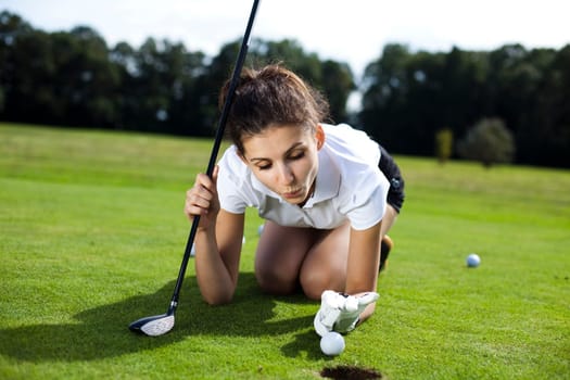 Young woman playing golf