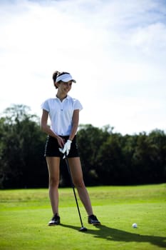Young woman playing golf