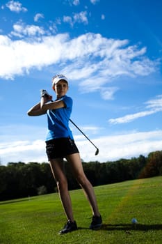 Young woman playing golf