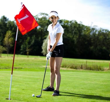 Woman playing golf on field