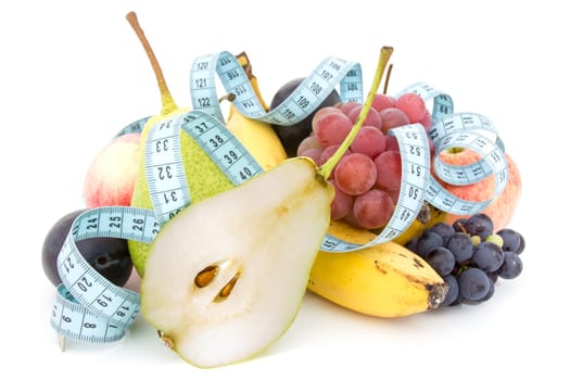 Measure tape and fruits composition over a white background