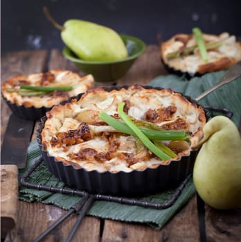 Pear tart with candied garlic and spring onions