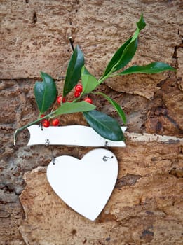 Rustic background with Christmas decorations and holly branches
