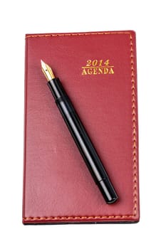 Agenda 2014 leather notebook and pen isolated on the white background