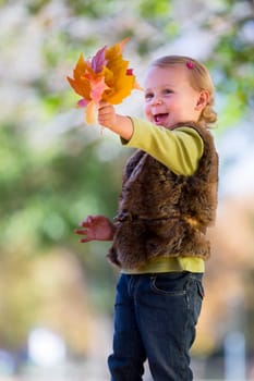 cute little girl with autumn leaves