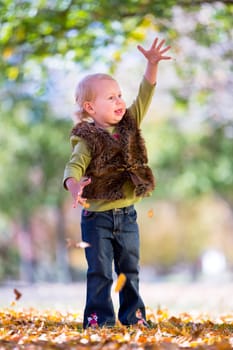cute little girl with autumn leaves