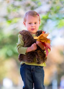 cute little girl with autumn leaves