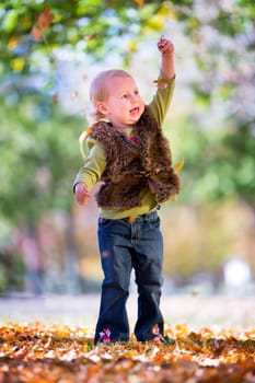 cute little girl with autumn leaves