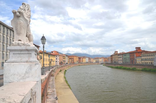 Picturesque colorful historic buildings along Arno river in Pisa, Italy