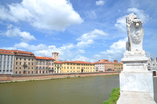 Picturesque colorful historic buildings along Arno river in Pisa, Italy