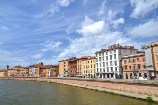 Picturesque colorful historic buildings along Arno river in Pisa, Italy
