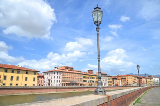 Picturesque colorful historic buildings along Arno river in Pisa, Italy
