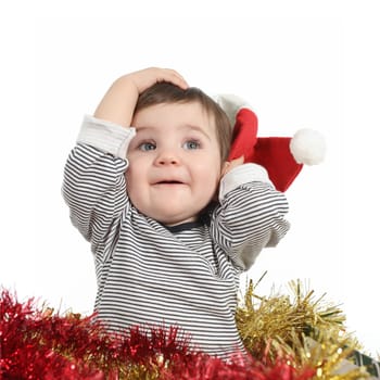 Pretty baby girl holding a santa claus hat isolated on a white background