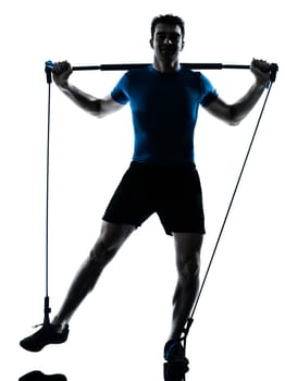 one caucasian man exercising gymstick workout fitness in silhouette studio  isolated on white background