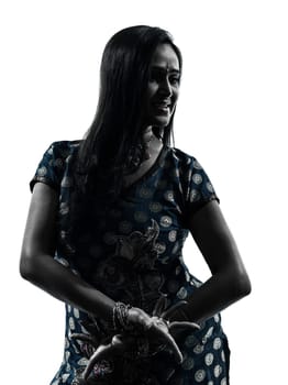 one indian woman in silhouette studio isolated on white background