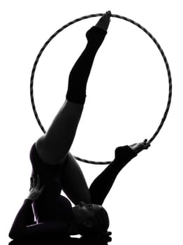 one caucasian woman exercising Rhythmic Gymnastics hula hoop  in silhouette studio isolated on white background