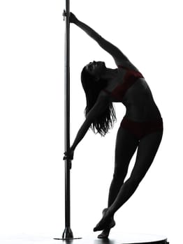 one caucasian woman pole dancer dancing in silhouette studio isolated on white background