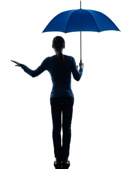 one caucasian woman holding umbrella umbrella palm gesture   in silhouette studio isolated on white background