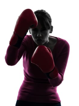 one caucasian woman with boxing gloves  in silhouette studio isolated on white background