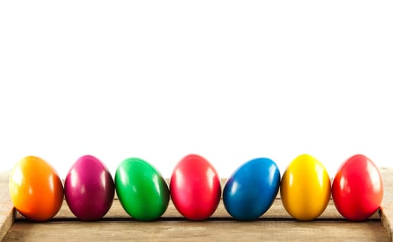 Colorful easter eggs on old wooden background. Easter concept. The colorful painted Easter eggs