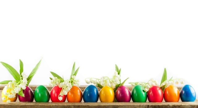 Colorful easter eggs on old wooden background. Easter concept. The colorful painted Easter eggs