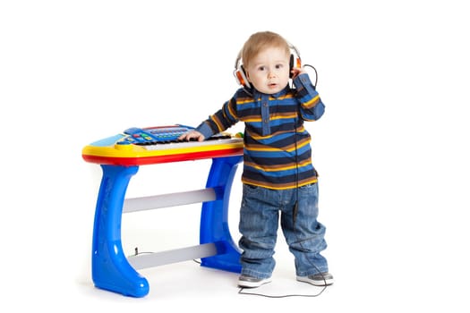 little boy and the keyboard on white background. funny boy baby. young DJ