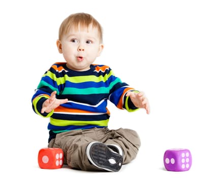 baby is playing with  toys over white background. Funny little kid playing with cup toys