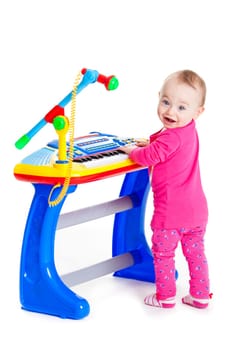 little girl and the keyboard on white background. funny girl. young DJ