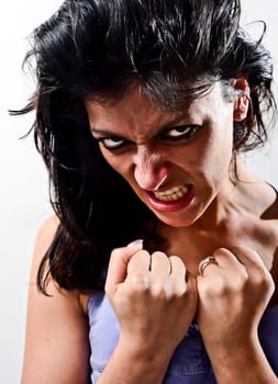 Angry woman in a position of self-defense