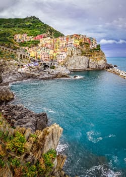 Scenic view of colorful village Manarola and ocean coast in Cinque Terre, Italy