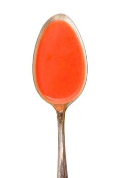 White-freed tomato soup on a spoon