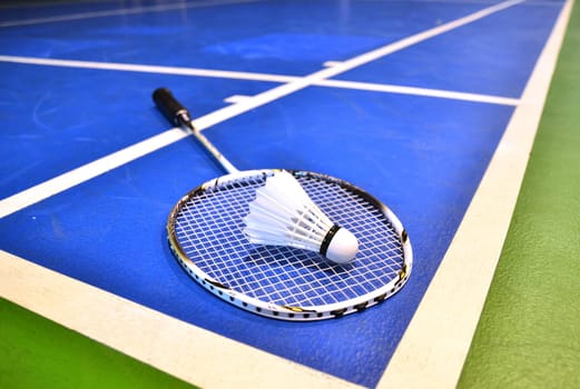badminton court with a shuttlecock at the corner