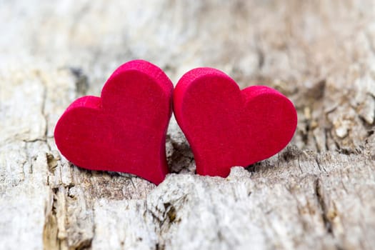 two red hearts on wooden background