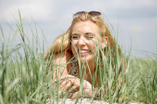 Young woman lies in the dunes