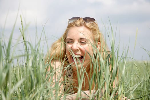 Young woman lies in the dunes